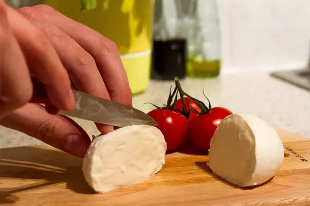 slicing fresh mozzarella