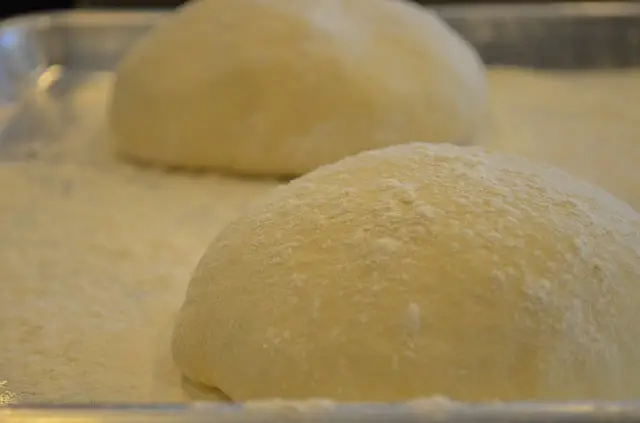 pizza dough rising in pan